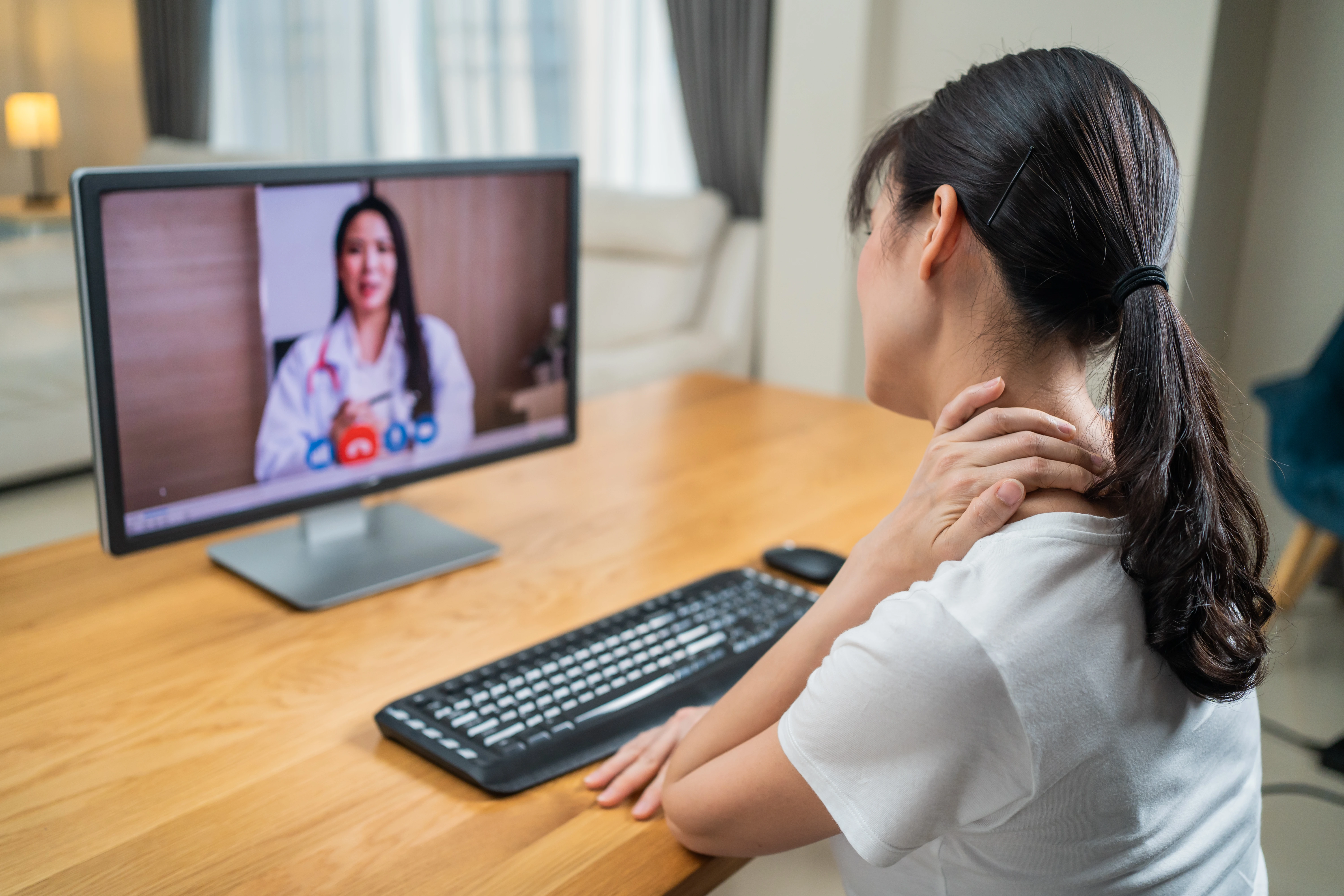 Woman receiving mental health support via video call doctor