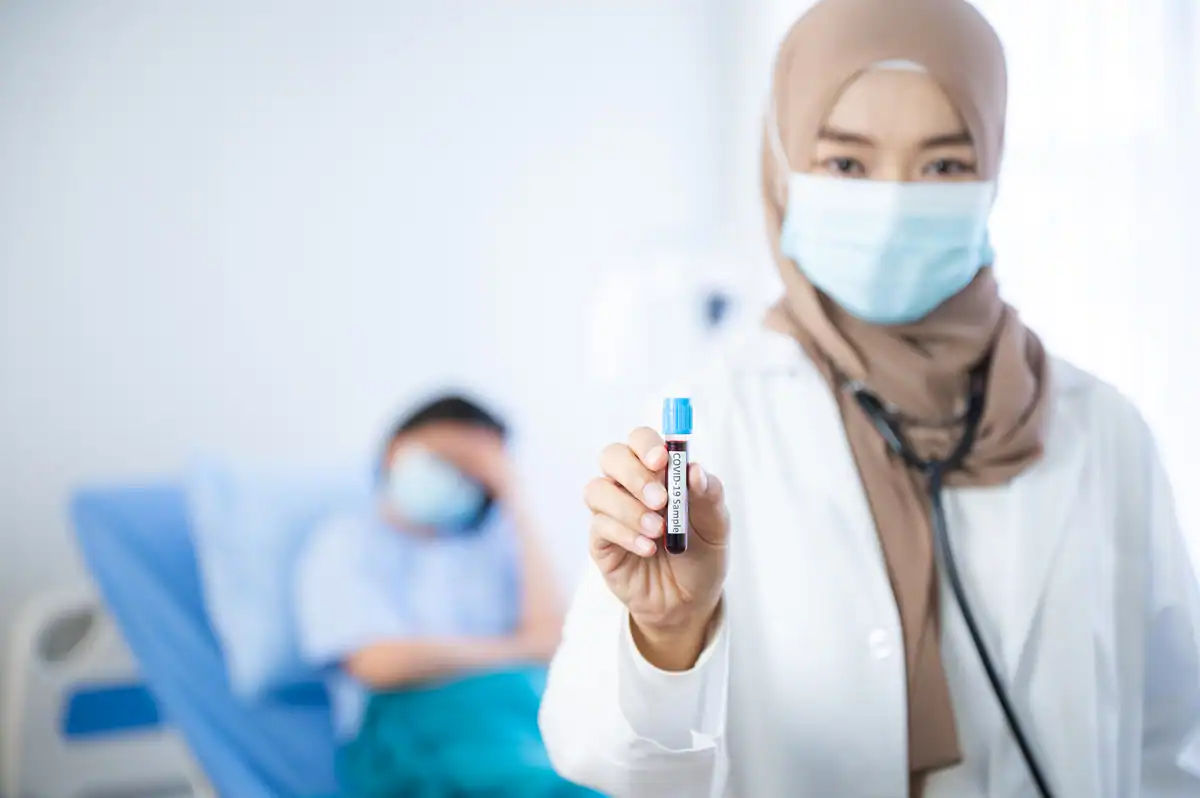 Umrah Vaccination Service in Singapore Muslim doctor preparing Umrah vaccination in Singapore clinic
